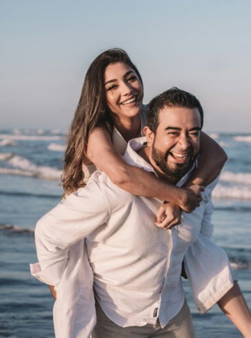 man in white dress shirt hugging woman in white dress